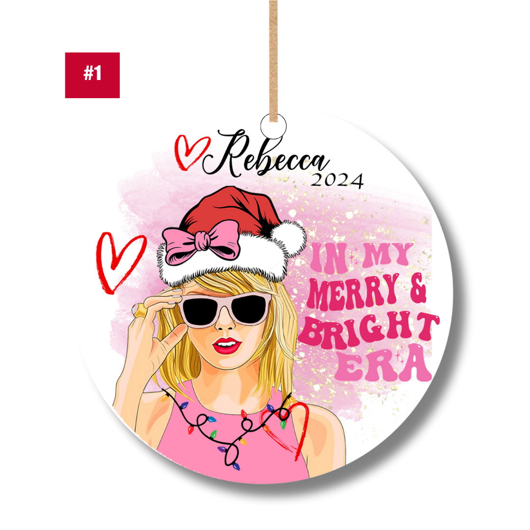 Swiftie fan-inspired ornament in pink design with Santa hat and lights – personalized Merry & Bright Era ornament gift by XOXOPOP.